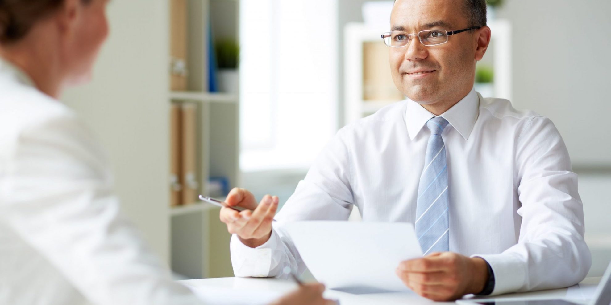 Photo of executive making an interview illustrates blog: Why Are Background Checks Important?