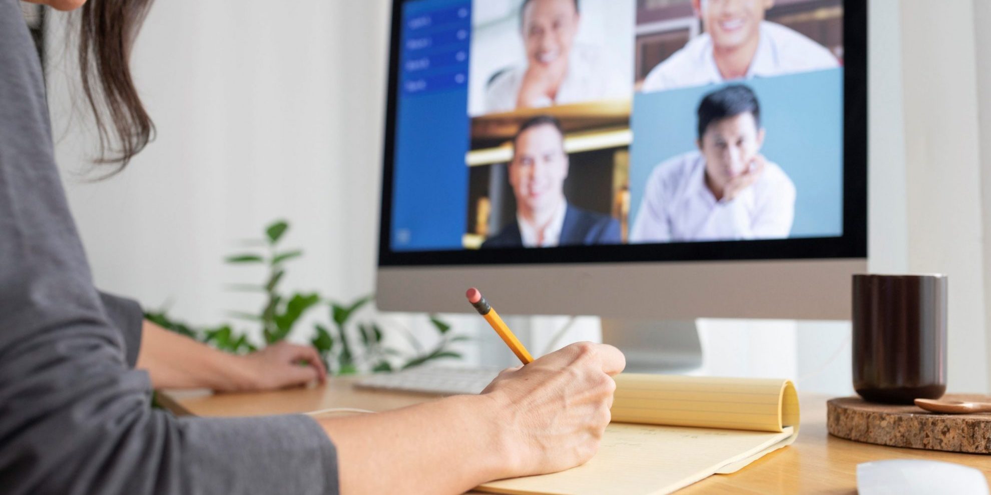 Photo of woman in front of computer illustrates blog: "4 Reasons Why Remote Work May Be the Right Choice for Your Company"