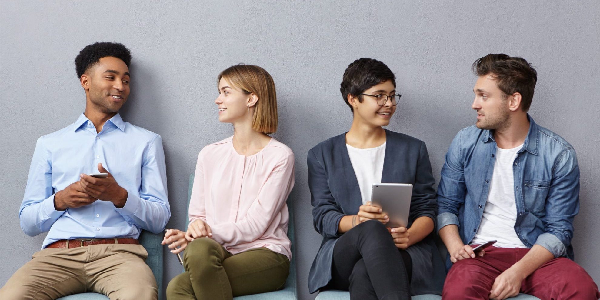 Photo of job candidates sitting next too each other illustrates blog: "Rapid Hiring: How to Do It Safely"