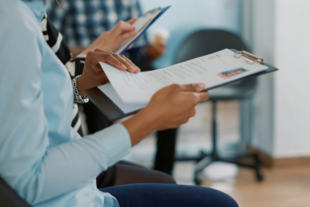 Photo of woman looking at resume illustrates blog: "Will Background Checks Show I Was Fired?"