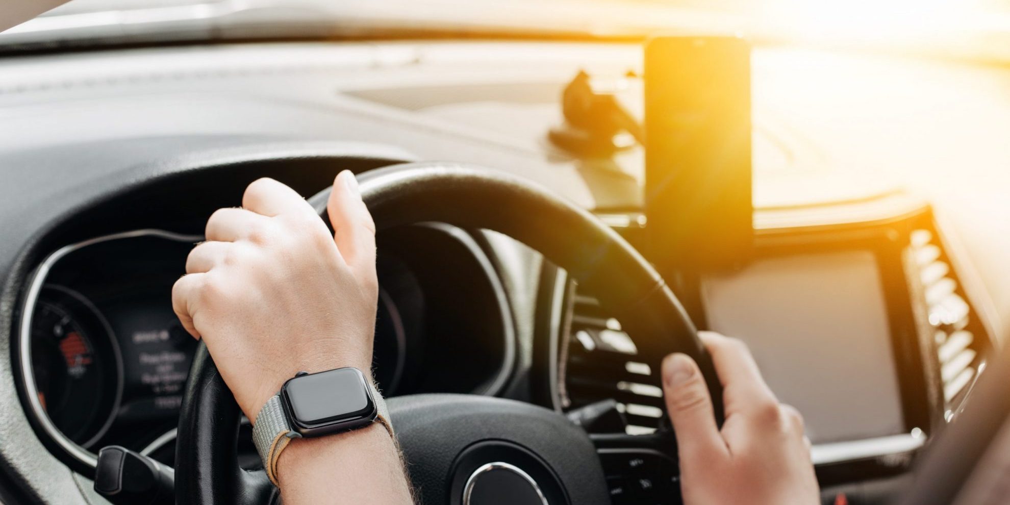 driving Closeup of person holding steering wheel illustrates blog "Will a Background Check Show a DUI?"
