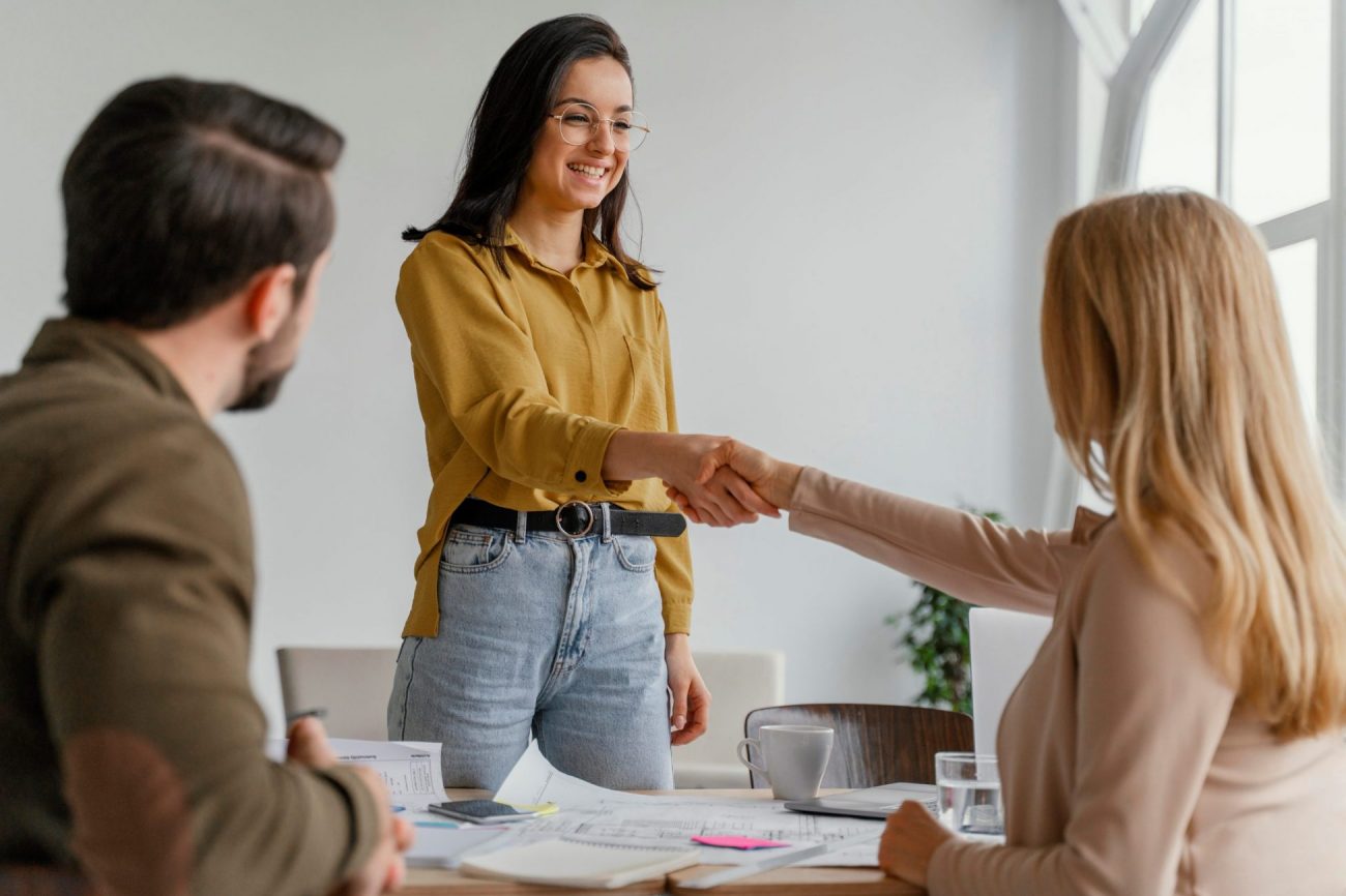 HandshakeWomen Photo of two women shaking hands illustrates blog "Background Check vs Resume: What Is the Difference?"