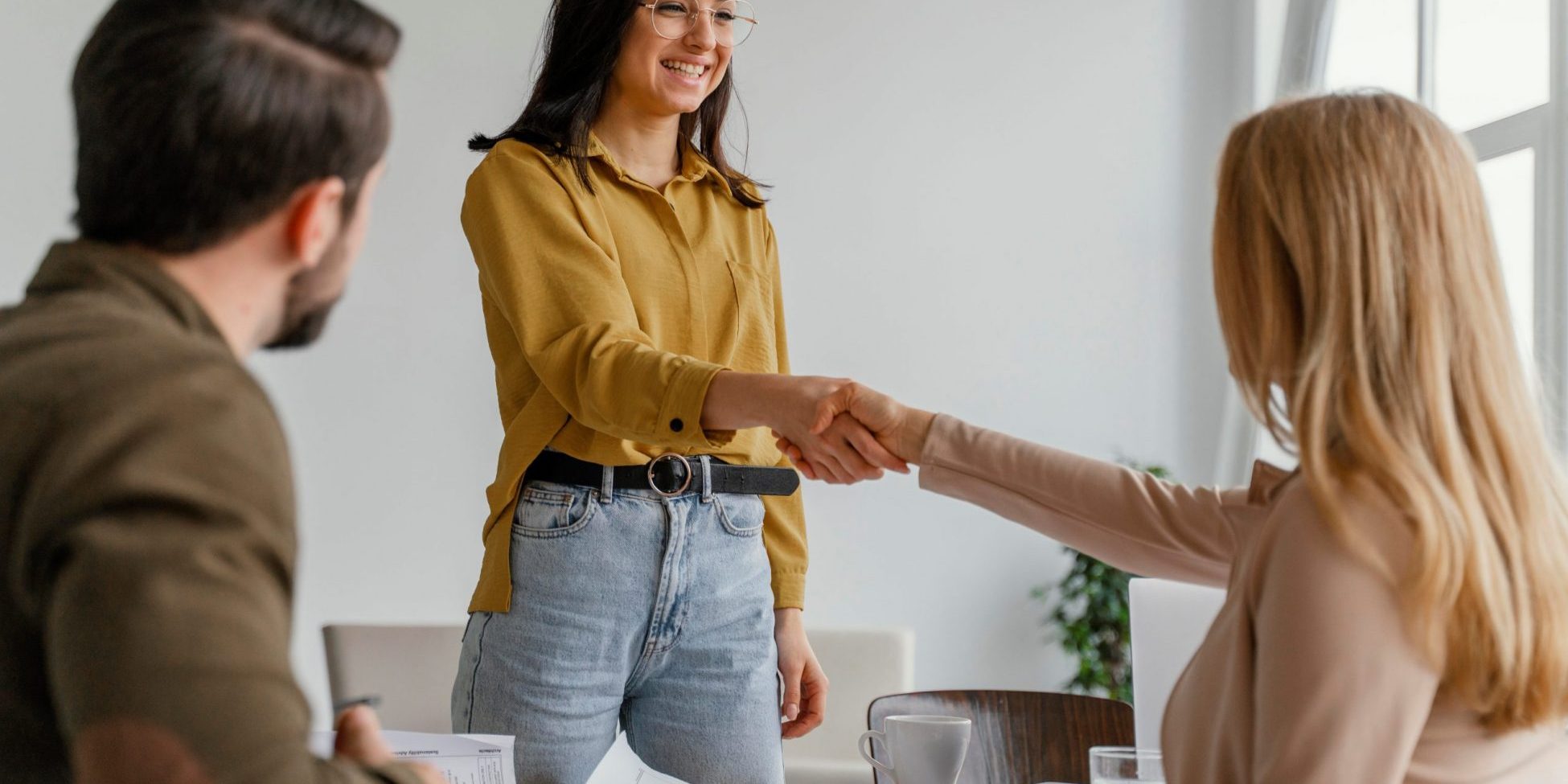 HandshakeWomen Photo of two women shaking hands illustrates blog "Background Check vs Resume: What Is the Difference?"
