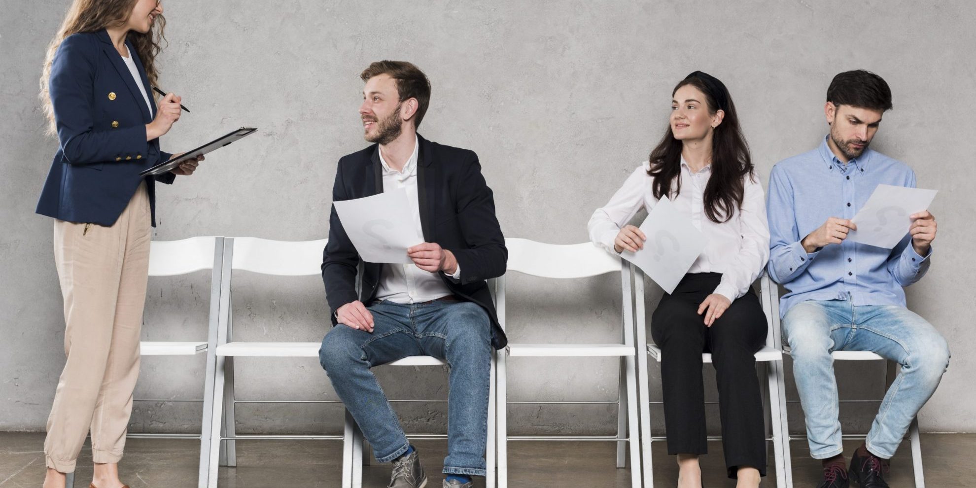 Woman talking to job candidates illustrates blog "How to Avoid Hiring Mistakes"