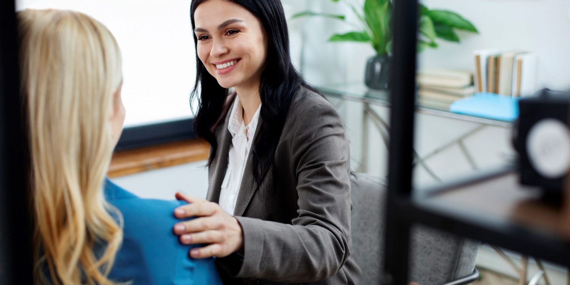 hIring-manager-FP2 Two women talking illustrate blog "5 Questions You Should Ask When Hiring a Manager"