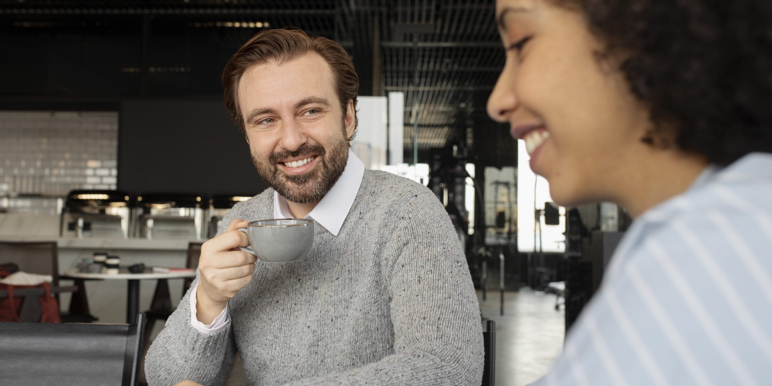 coworkers-FP Two coworkers drinking coffee during break illustrate blog "Why Is Recruiting Everyone's Job?"