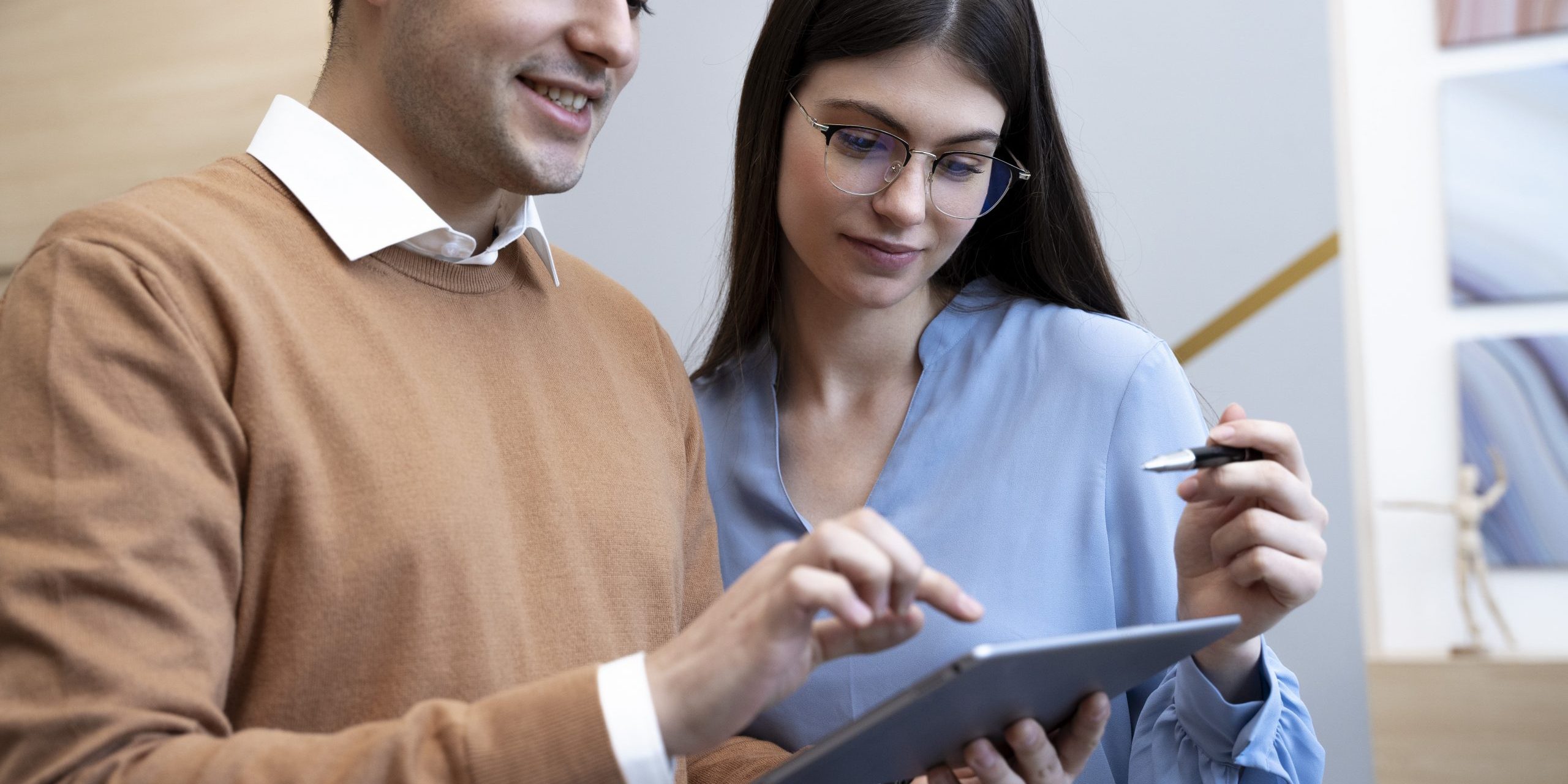 man-woman-office-fp Man and woman looking at tablet in office