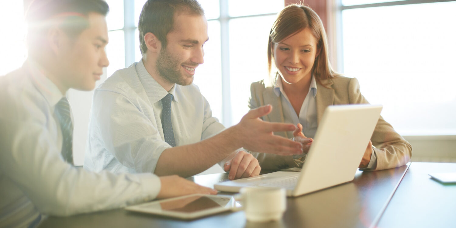co-workers-discussing-business-ideas Hiring team reviewing Washington fair chance employment compliance