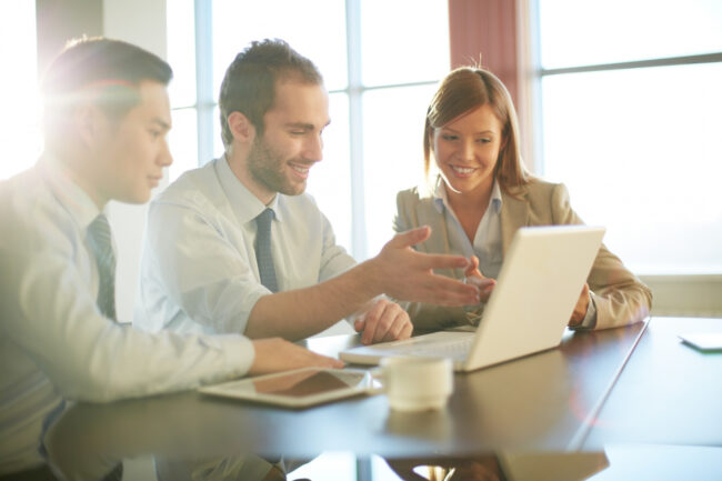 co-workers-discussing-business-ideas Hiring team reviewing Washington fair chance employment compliance